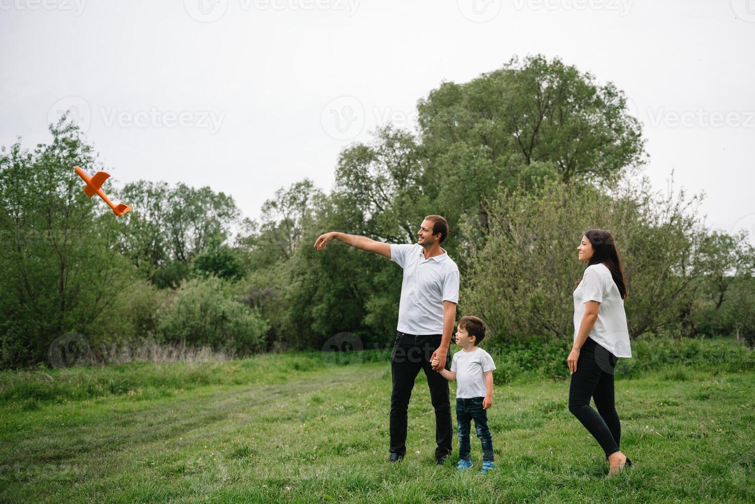 Happy family mother father and child son on nature on sunset. Mom, Dad and kid laughing and hugging, enjoying nature outside. Sunny day, good mood. concept of a happy family. photo