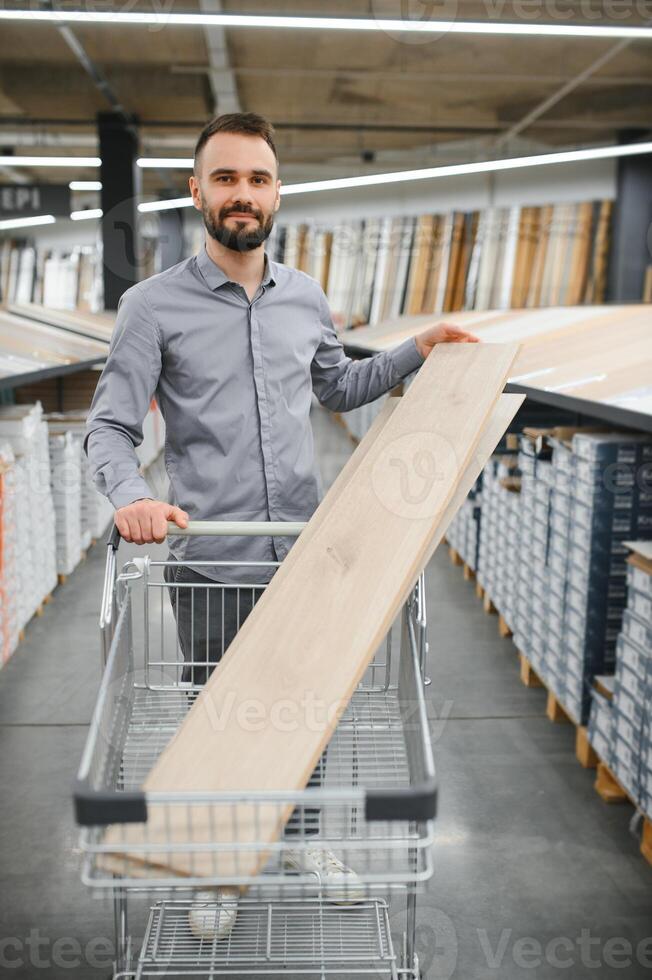 Man choosing flooring in hardware store photo