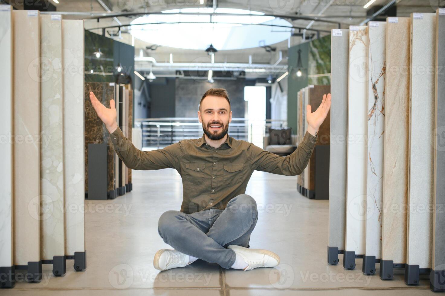 buyer examines ceramic tiles in a construction store photo