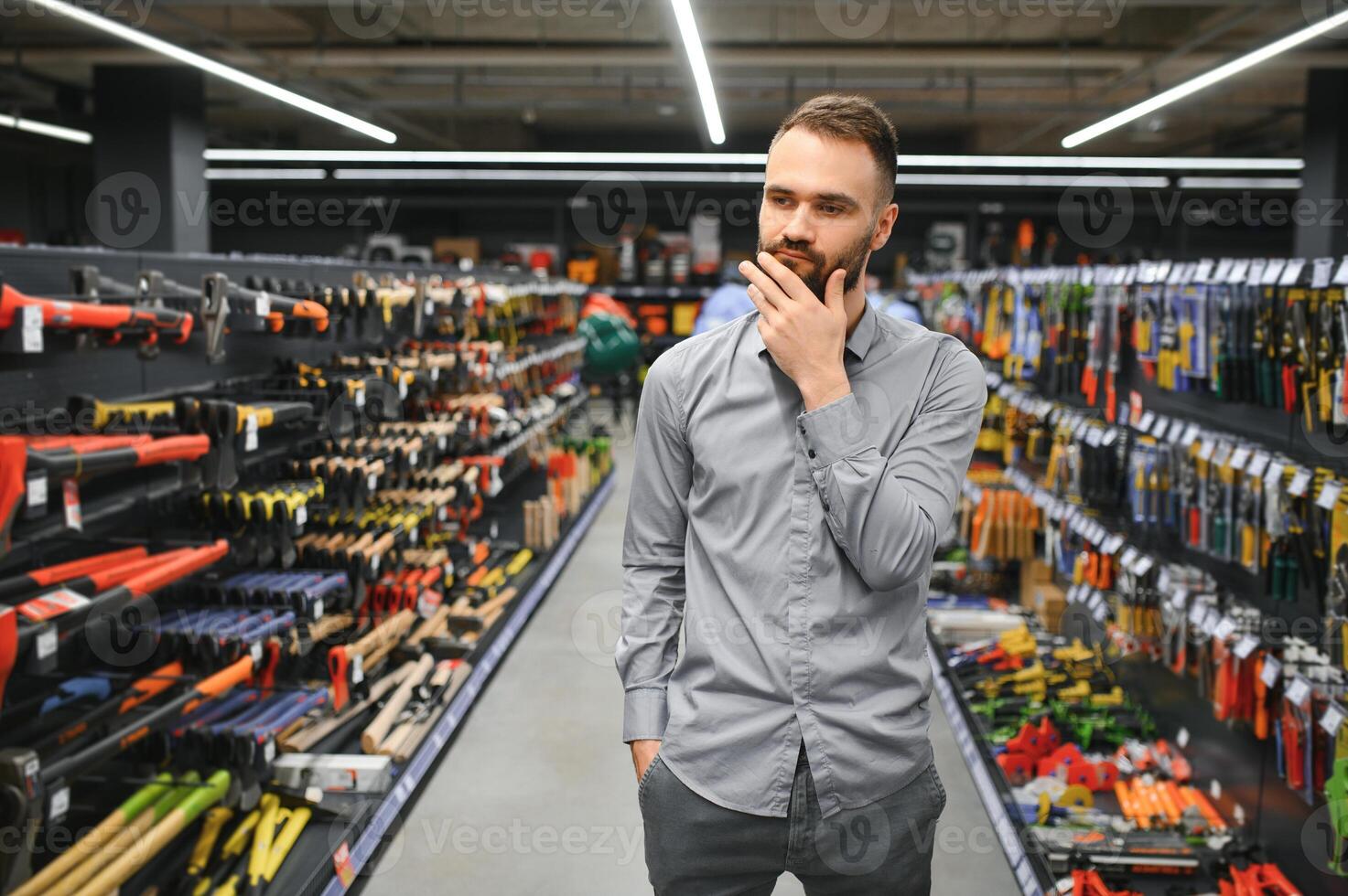 Portrait of happy mature man standing in hardware store photo