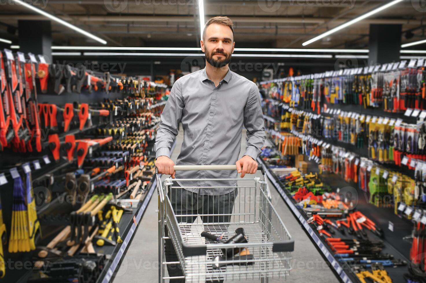 Portrait of happy mature man standing in hardware store photo