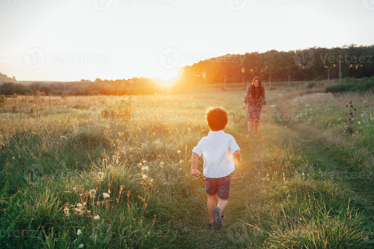 Stilish mother and handsome son having fun on the nature. Happy family concept. Beauty nature scene with family outdoor lifestyle. Happy family resting together. Happiness in family life. Mothers day photo