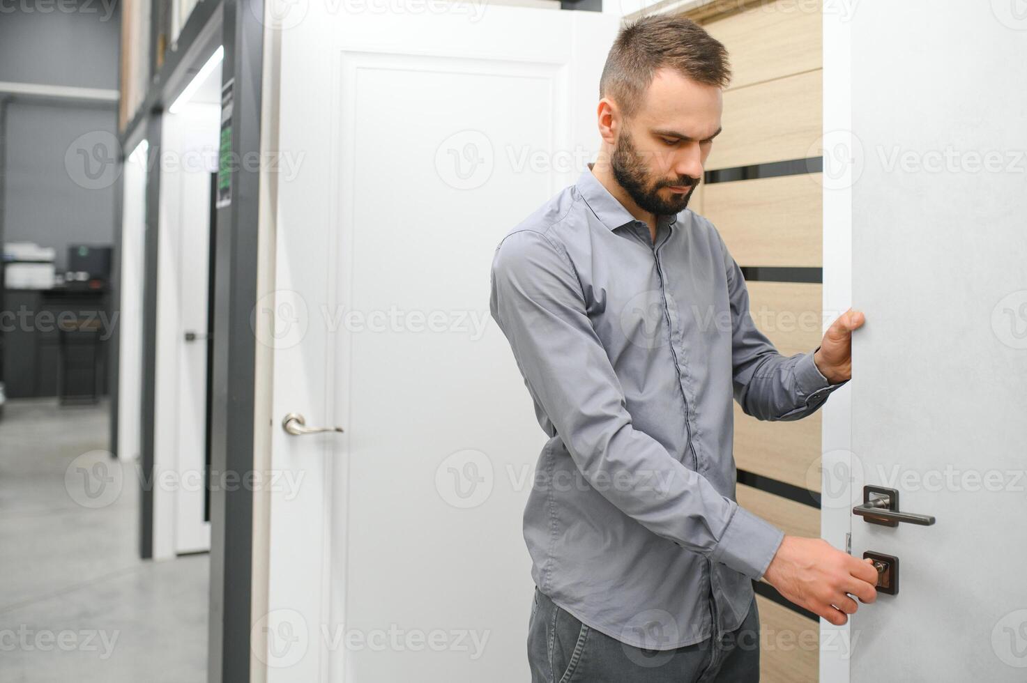 A man chooses doors in a hardware store for his apartment photo