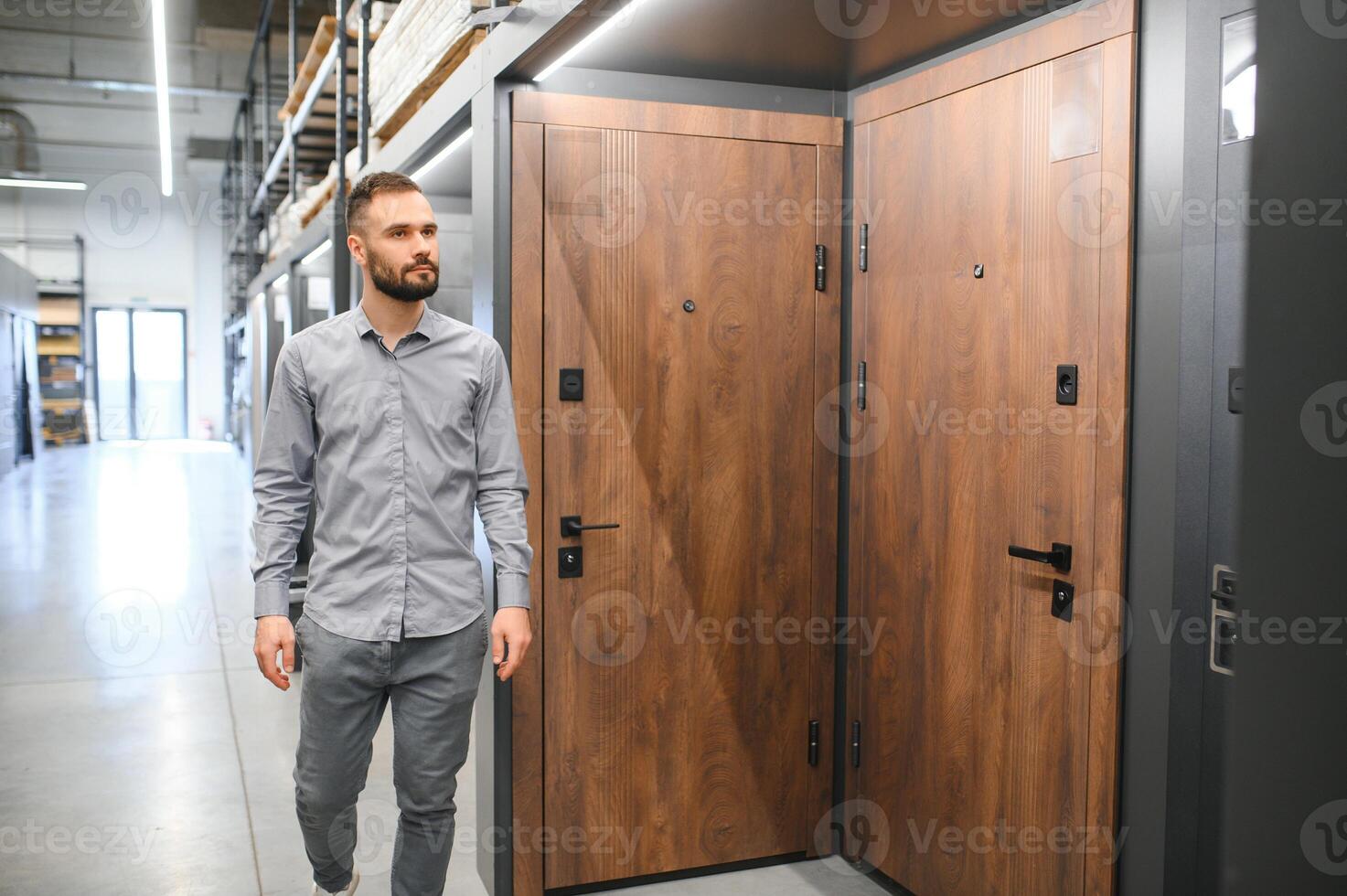 Buyer chooses door in store. Shop window of doors. A large selection of doors for house photo