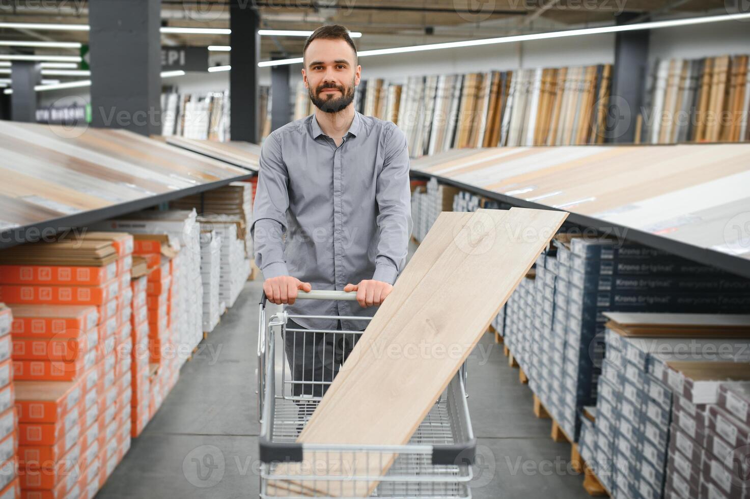 man choosing laminate samples in hardware store photo