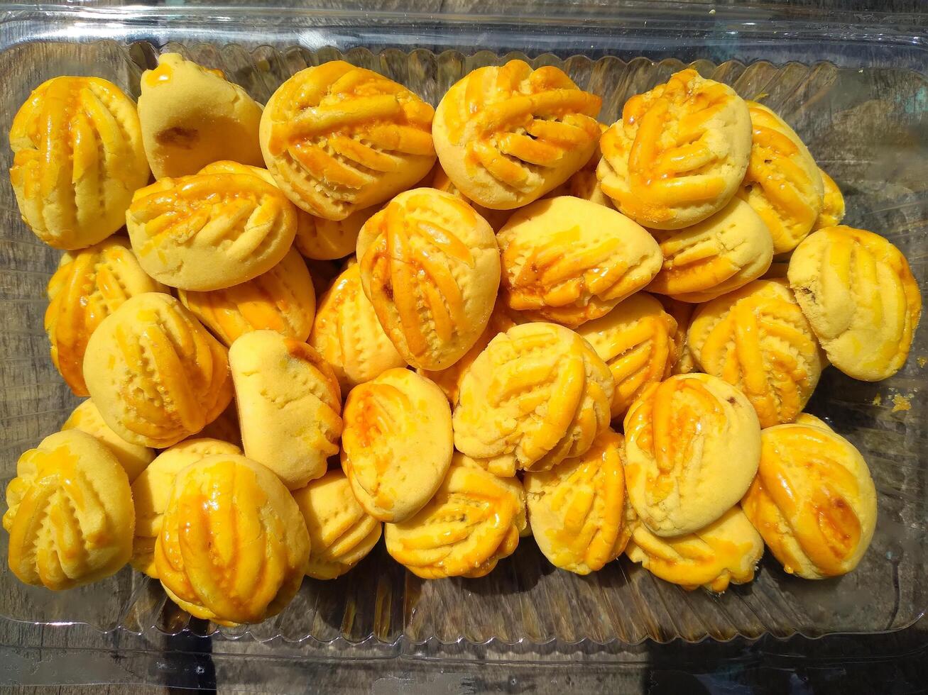 Close up of nastar cookies or pineapple tart lined up neatly on black cupcake paper. photo