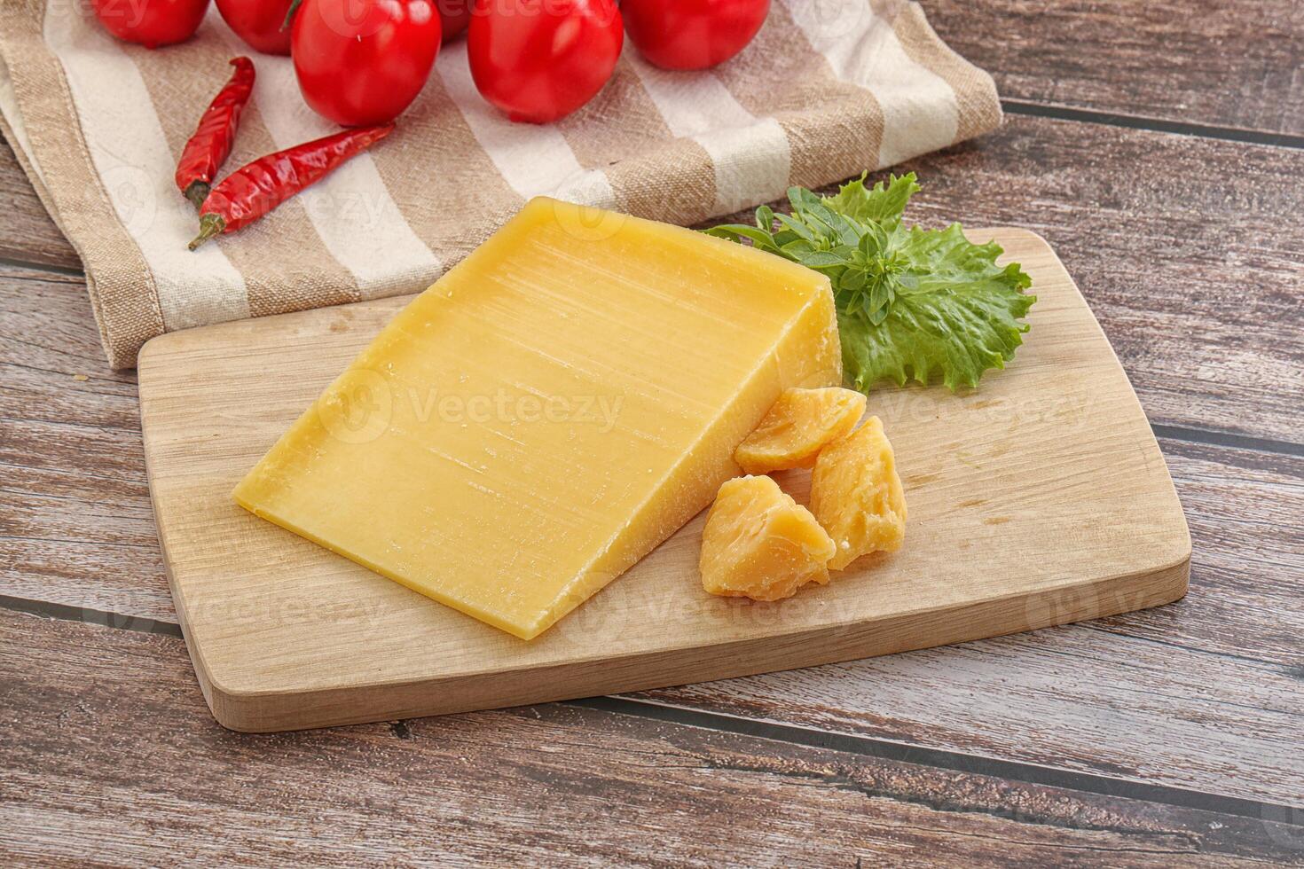 Parmesan hard cheese with small pieces photo