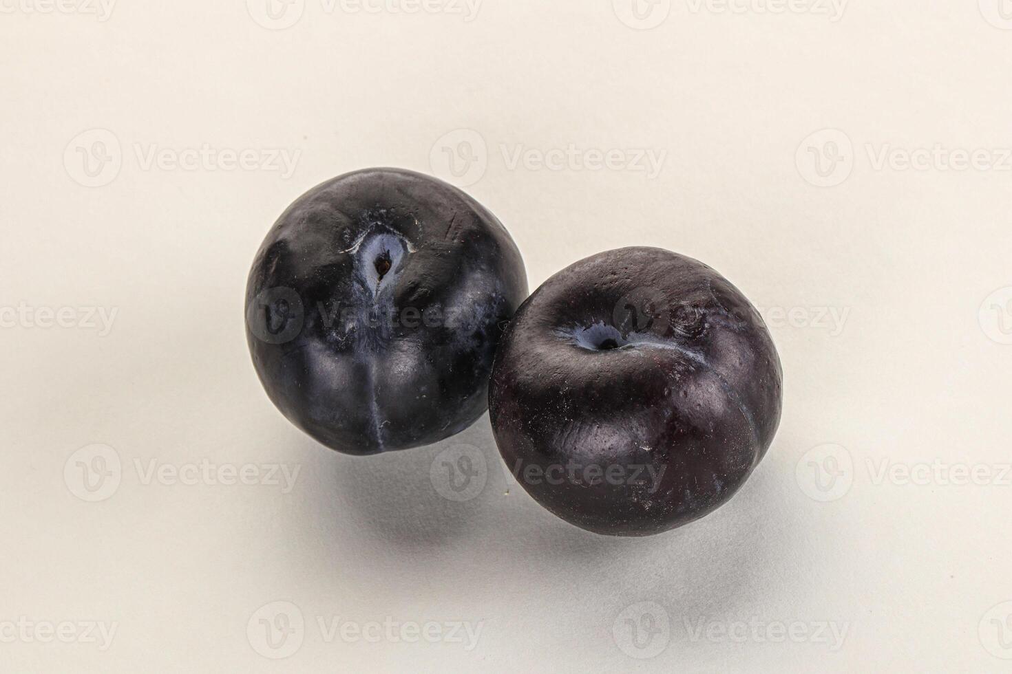 Two ripe sweet black plums photo