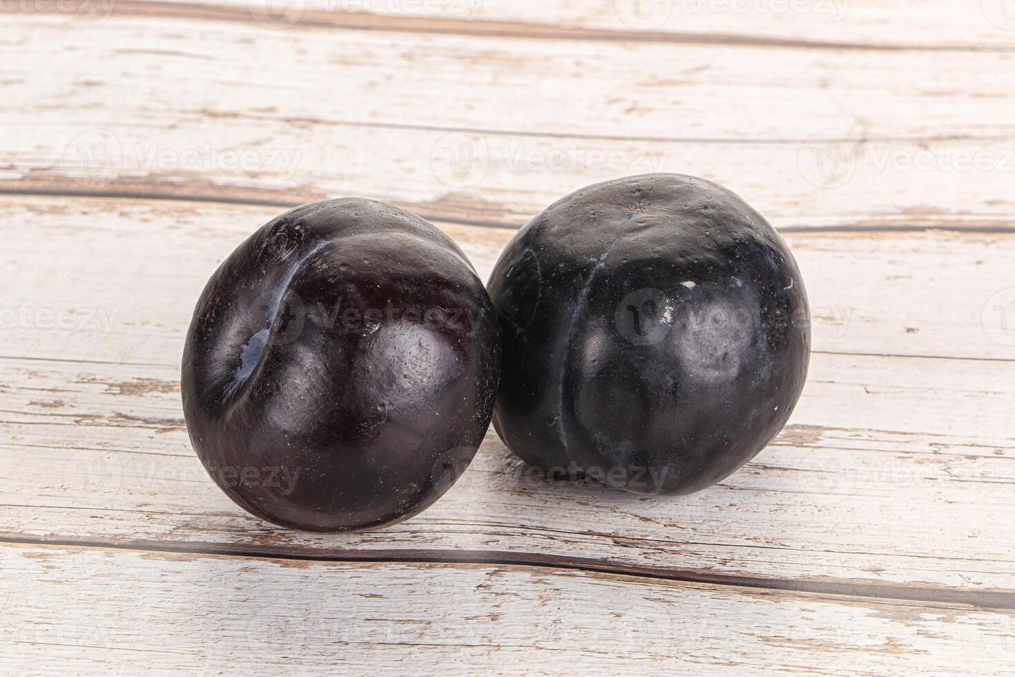 Two ripe sweet black plums photo