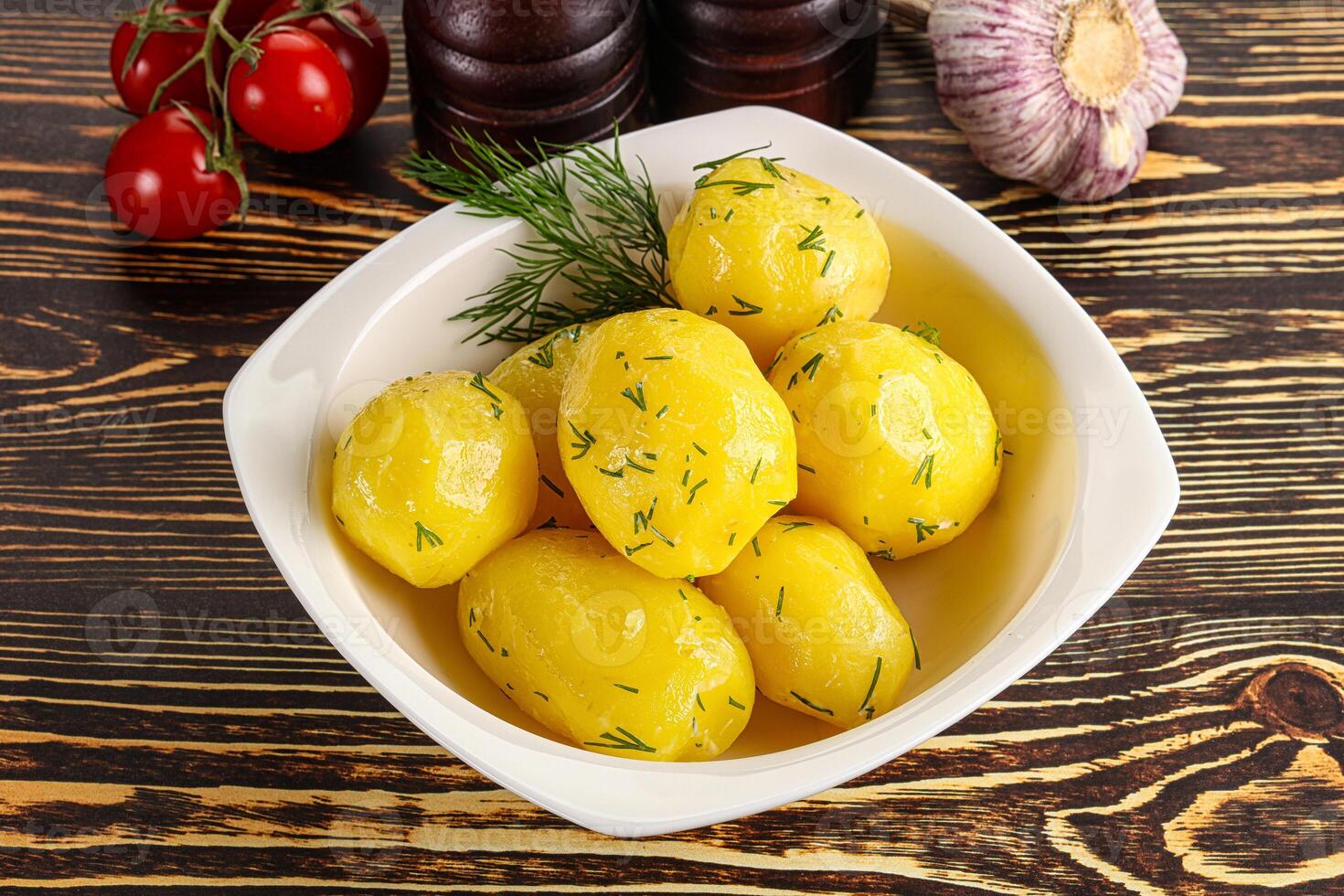Boiled potato with oil and dill photo