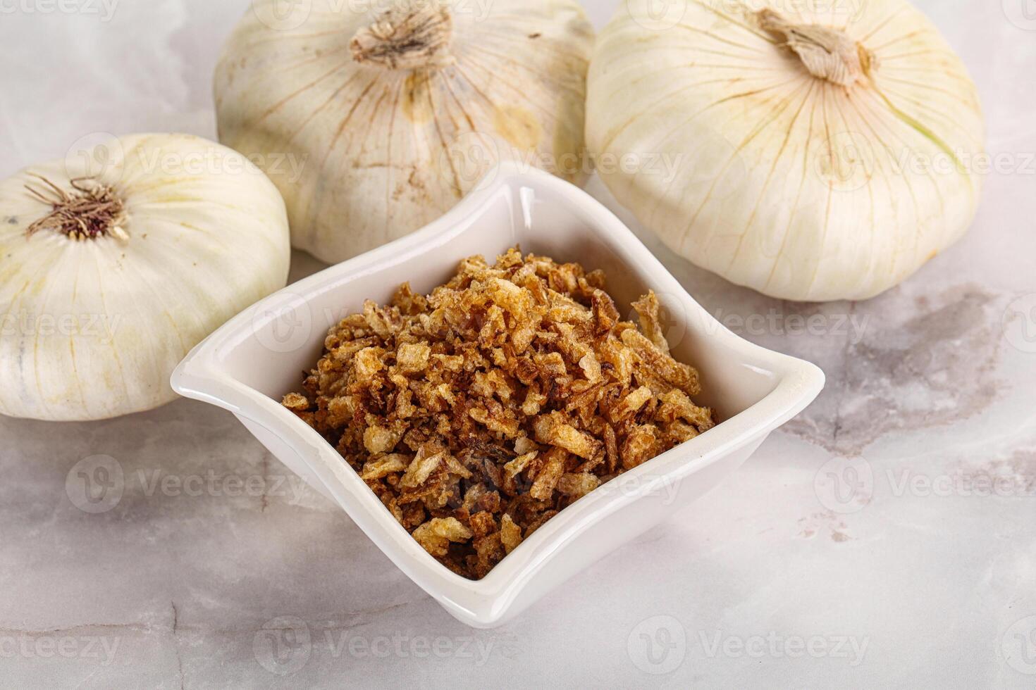 Dried roasted onion flakes for culinary photo