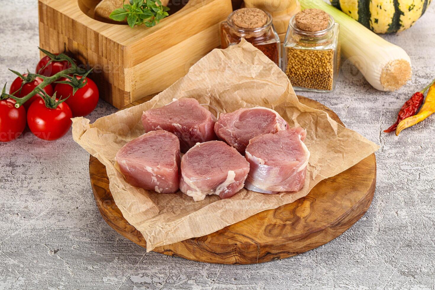 Uncooked raw pork tenderloin medallions photo