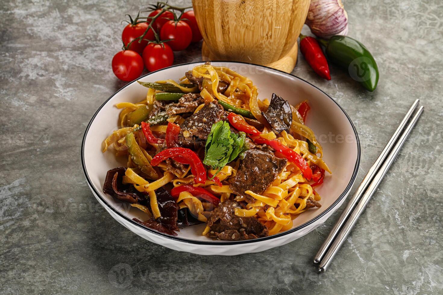 Asian wok with noodle, vegetables and beef photo