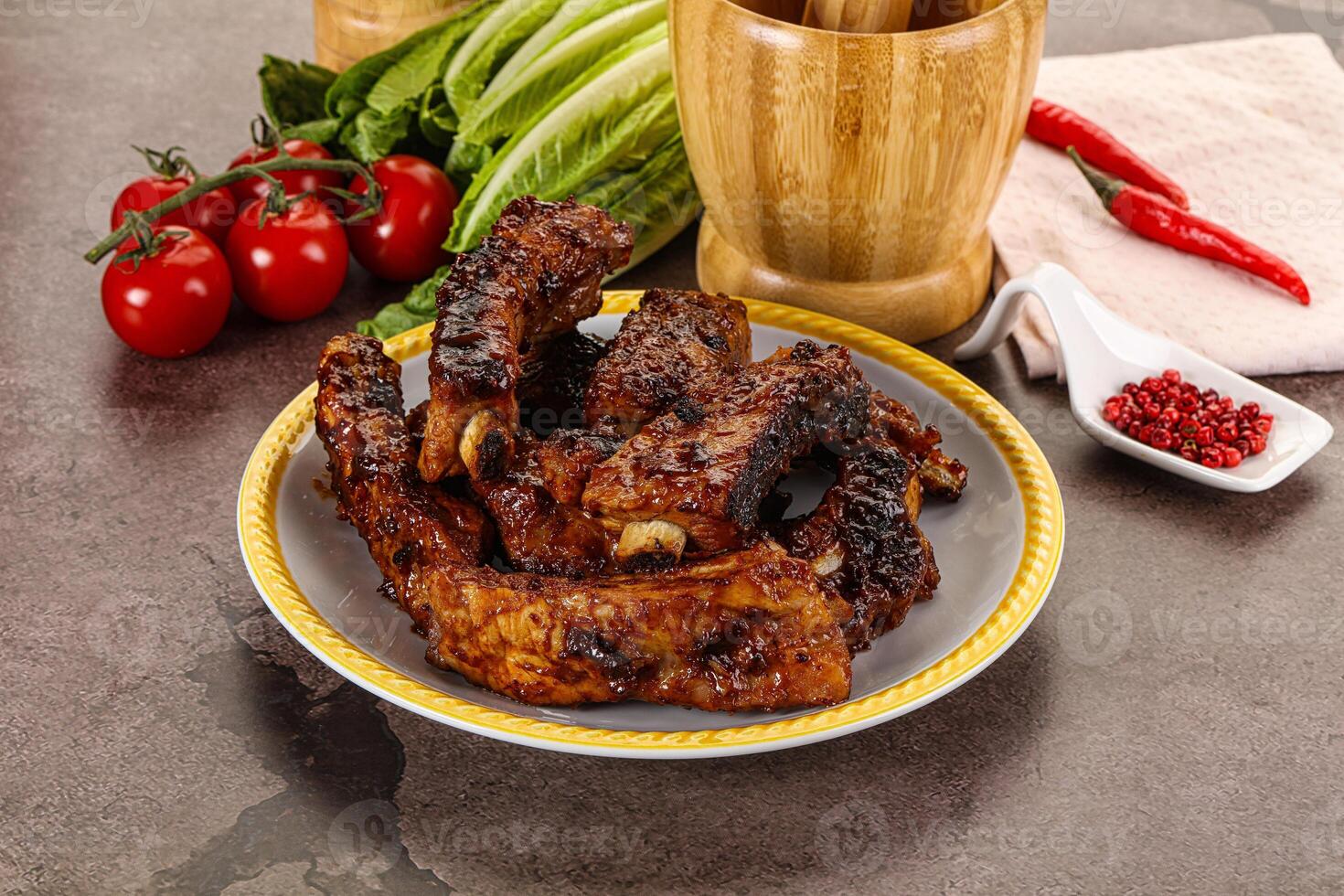 Grilled pork ribs in barbecue sauce photo