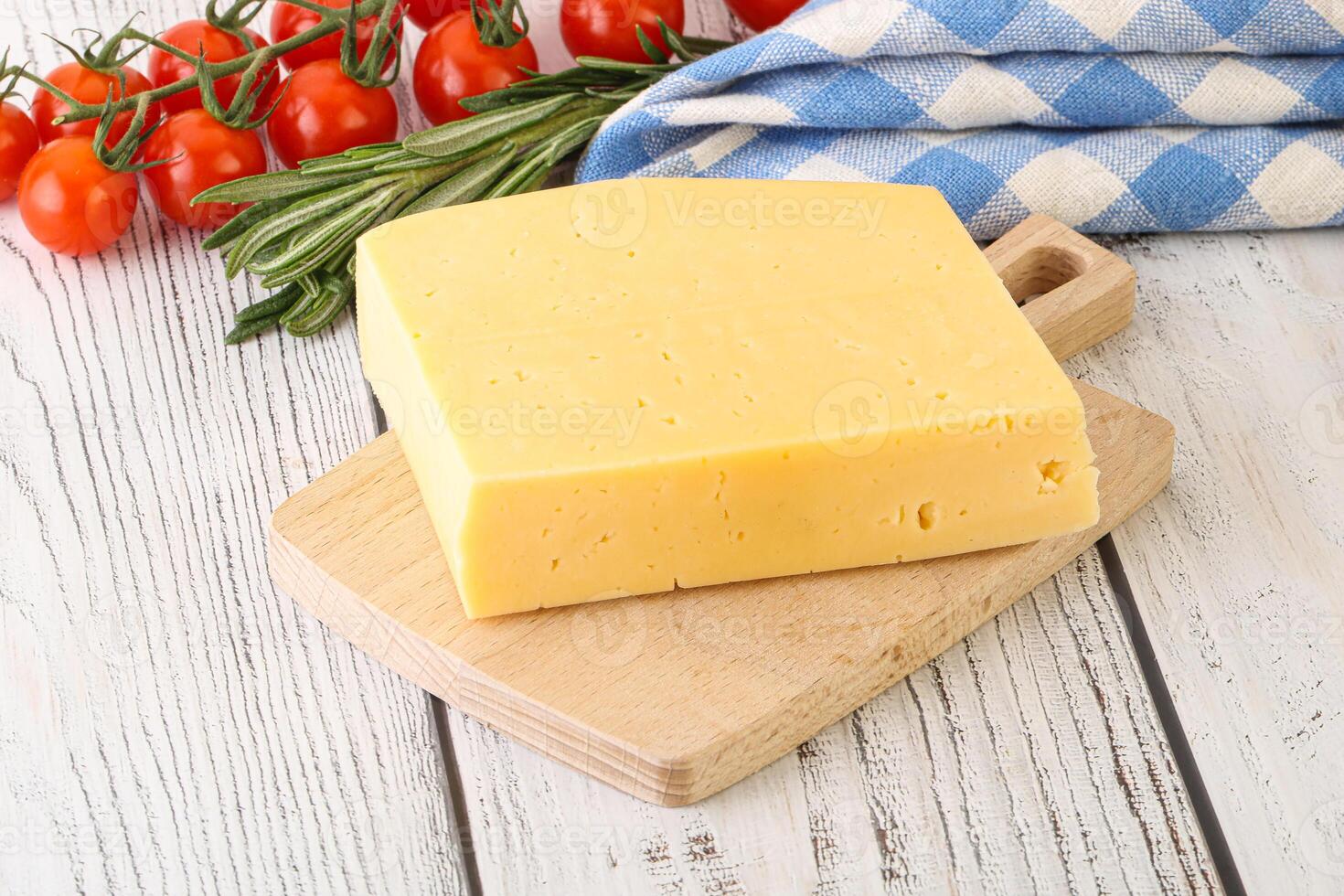 Piece of natural organic cheese over board photo