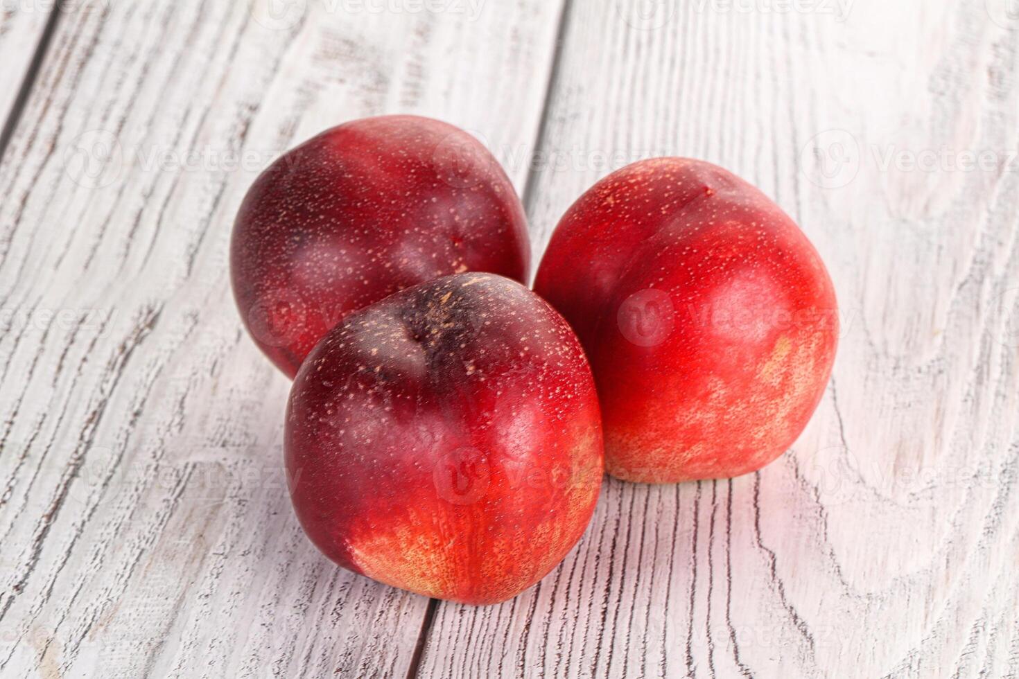 Ripe sweet juicy nectarines heap photo