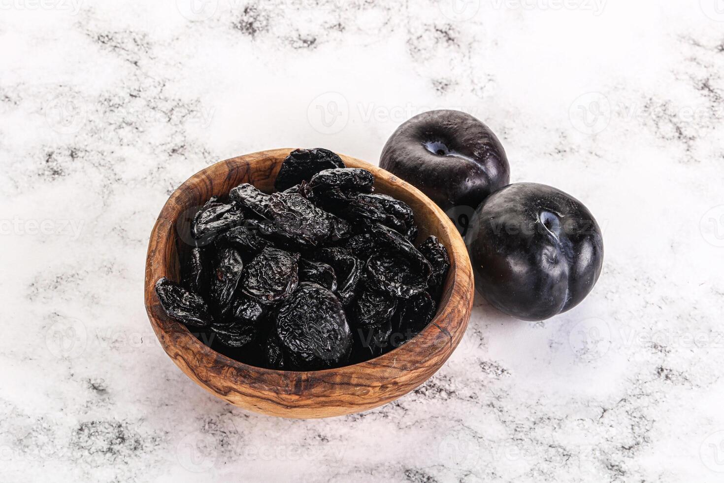 Dry prunes in thw bowl photo