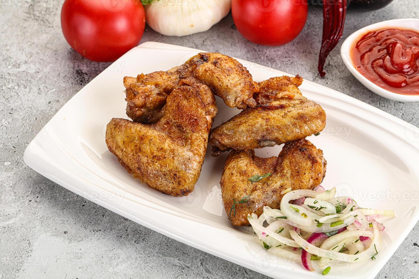 Grilled chicken wings with sauce photo