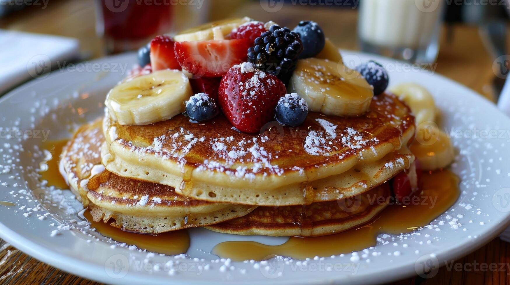 A stack of pancakes with strawberries and blueberries on top photo