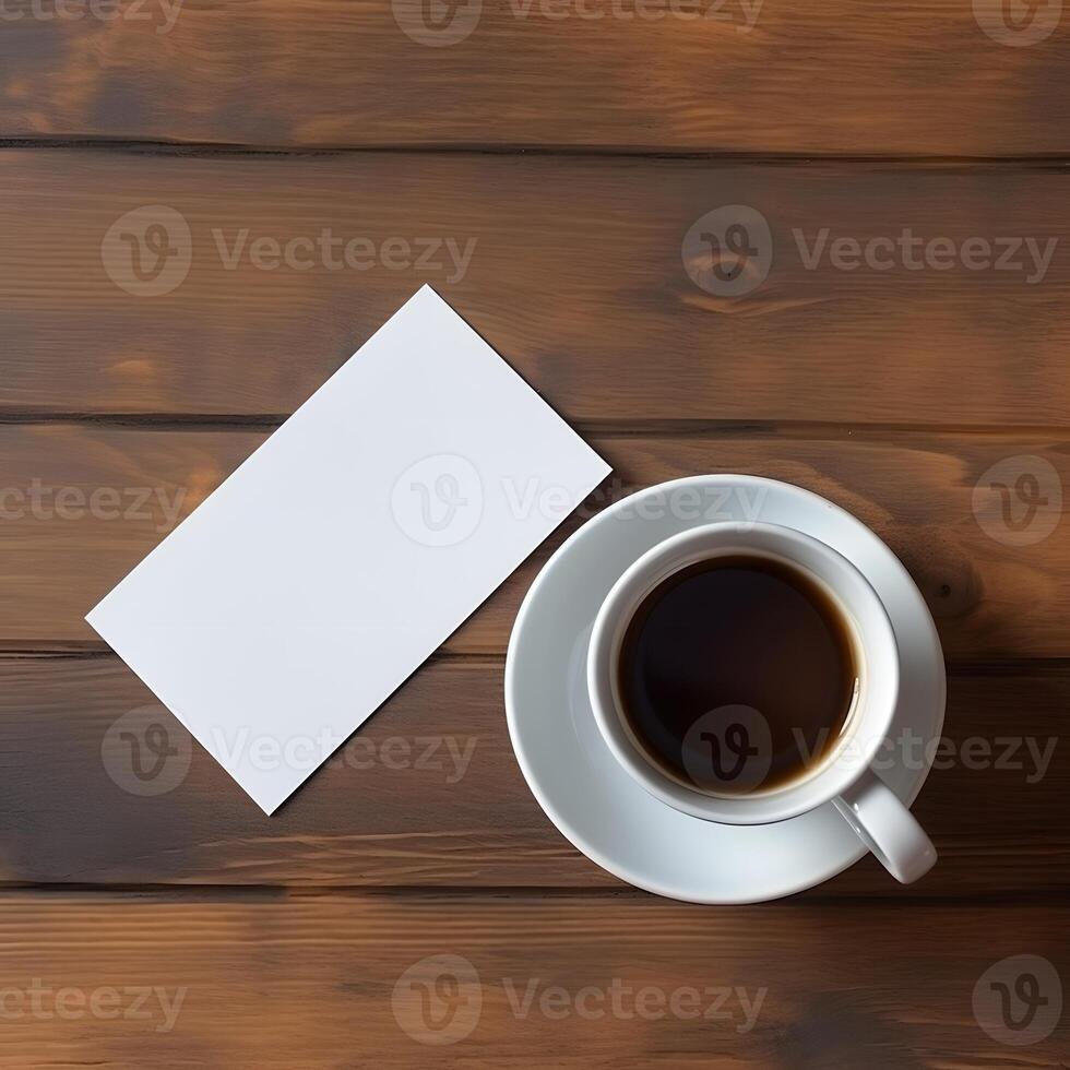 Business card mockup and a cup of coffee on a wooden background, top view. White namecard design mock up presentation photo