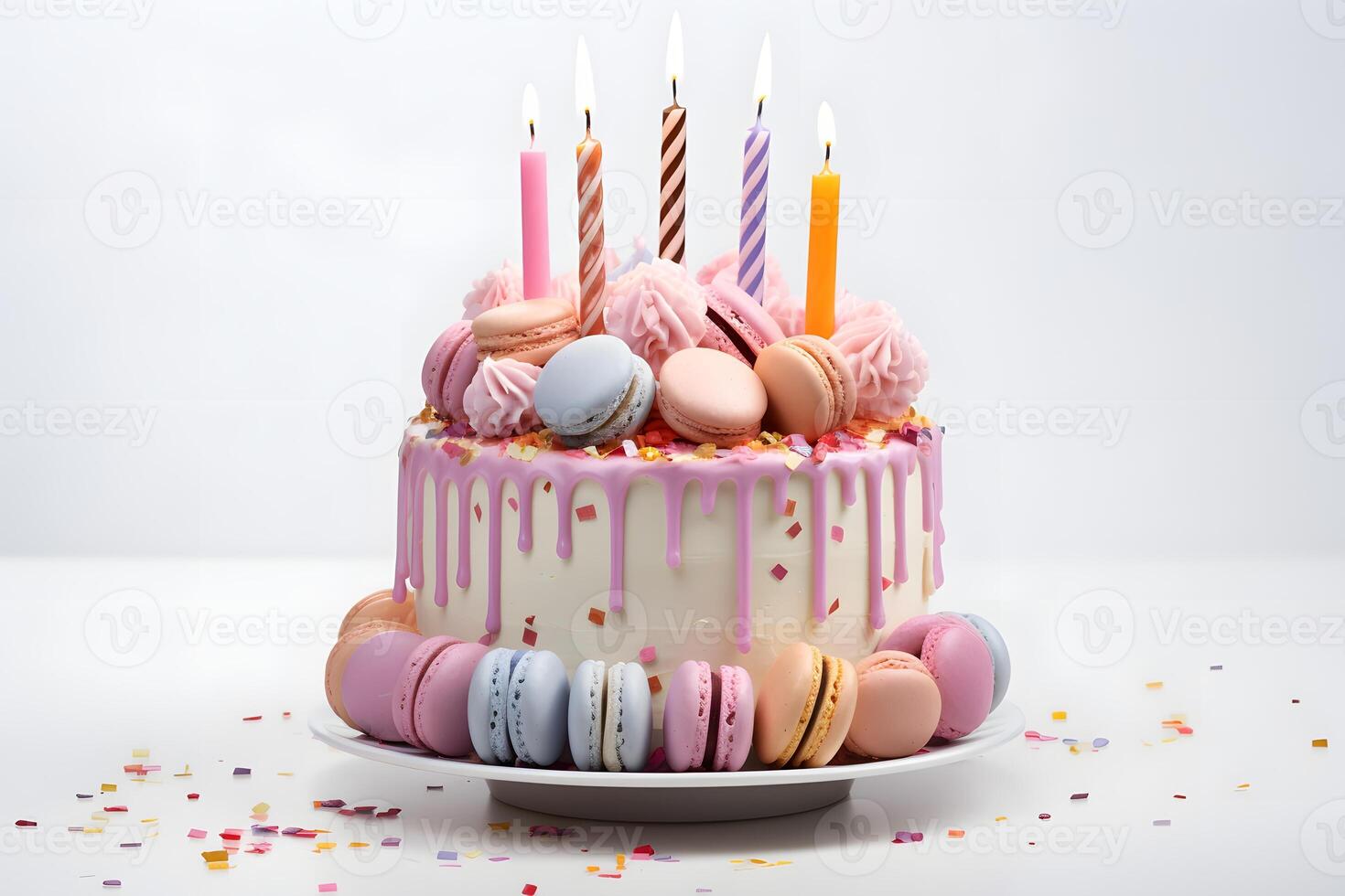 Celebration birthday cake with multicolored lit candles and macarons isolated on white background. Happy Birthday concept photo