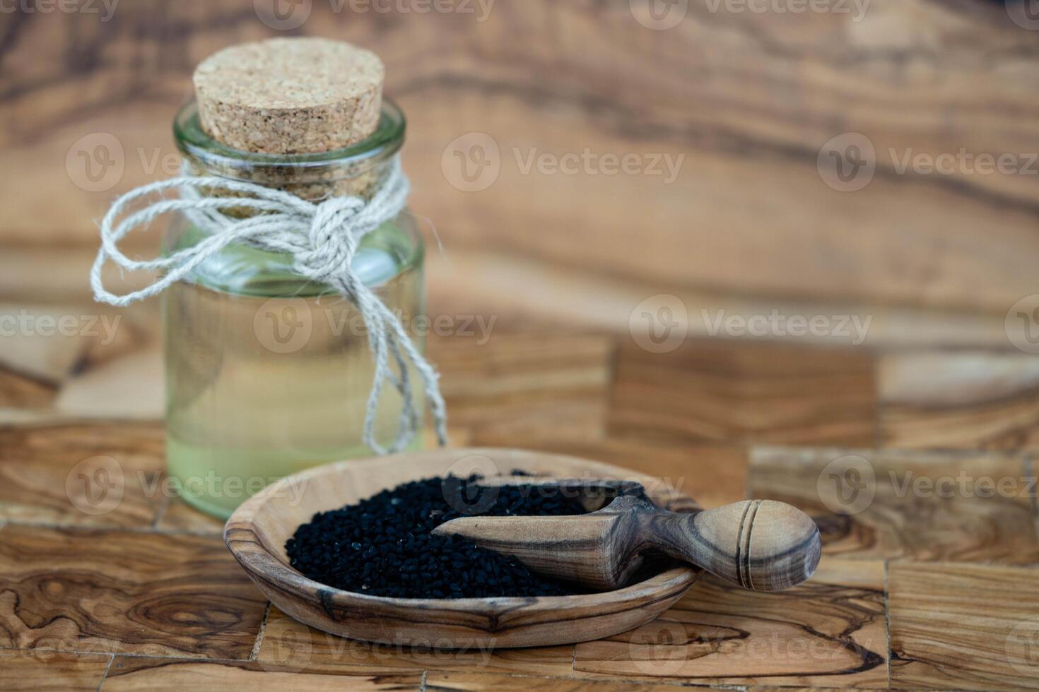 the roman coriander nigella sativa on olive wood photo