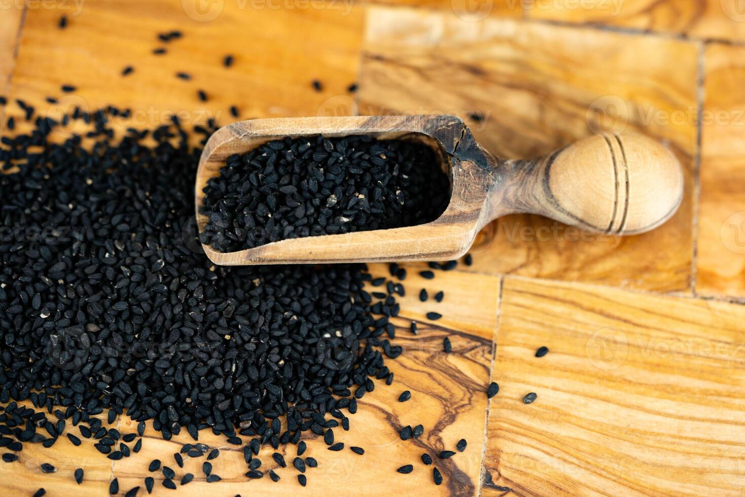 the roman coriander nigella sativa on olive wood photo