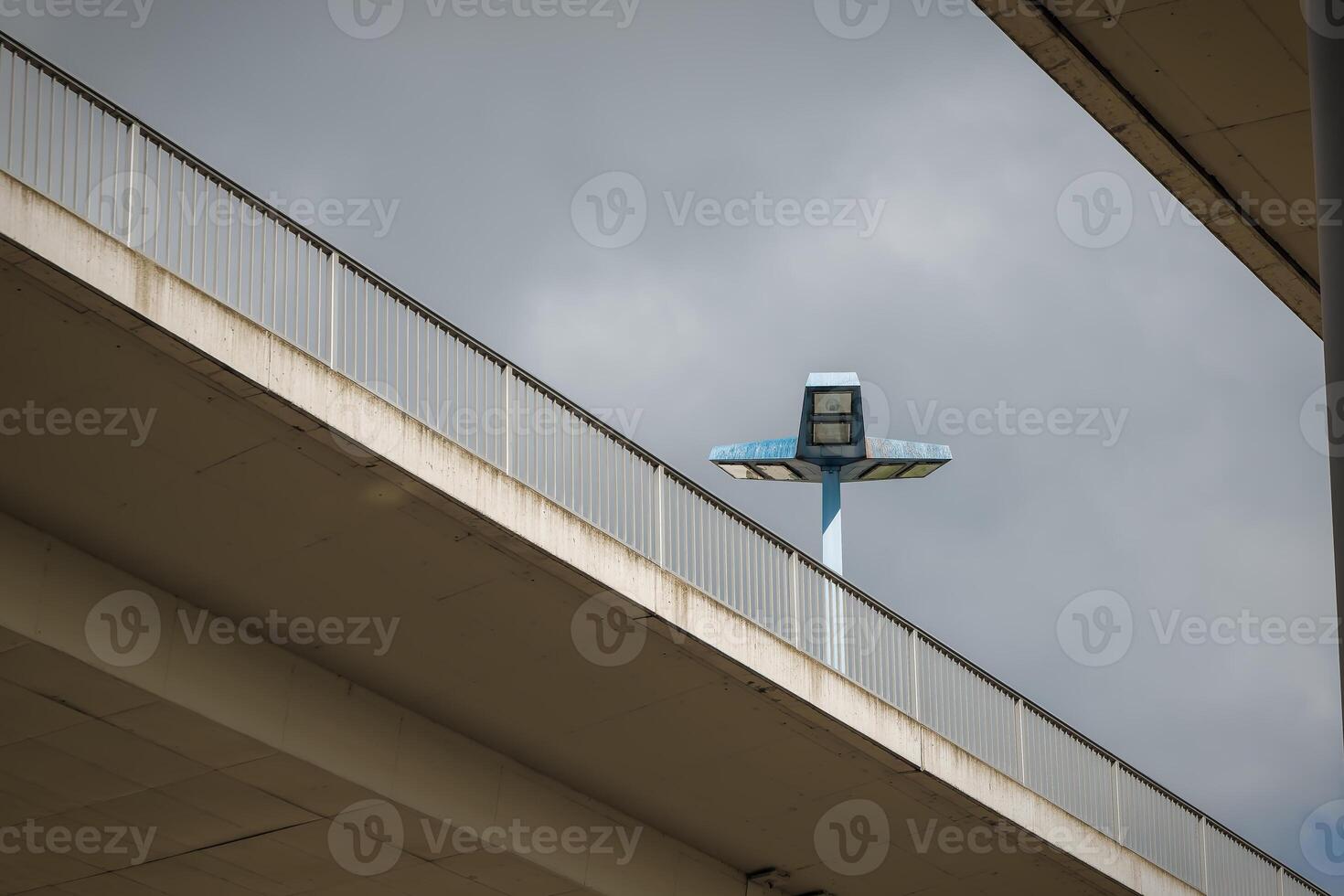 highway bridge with a floodlight in the background photo