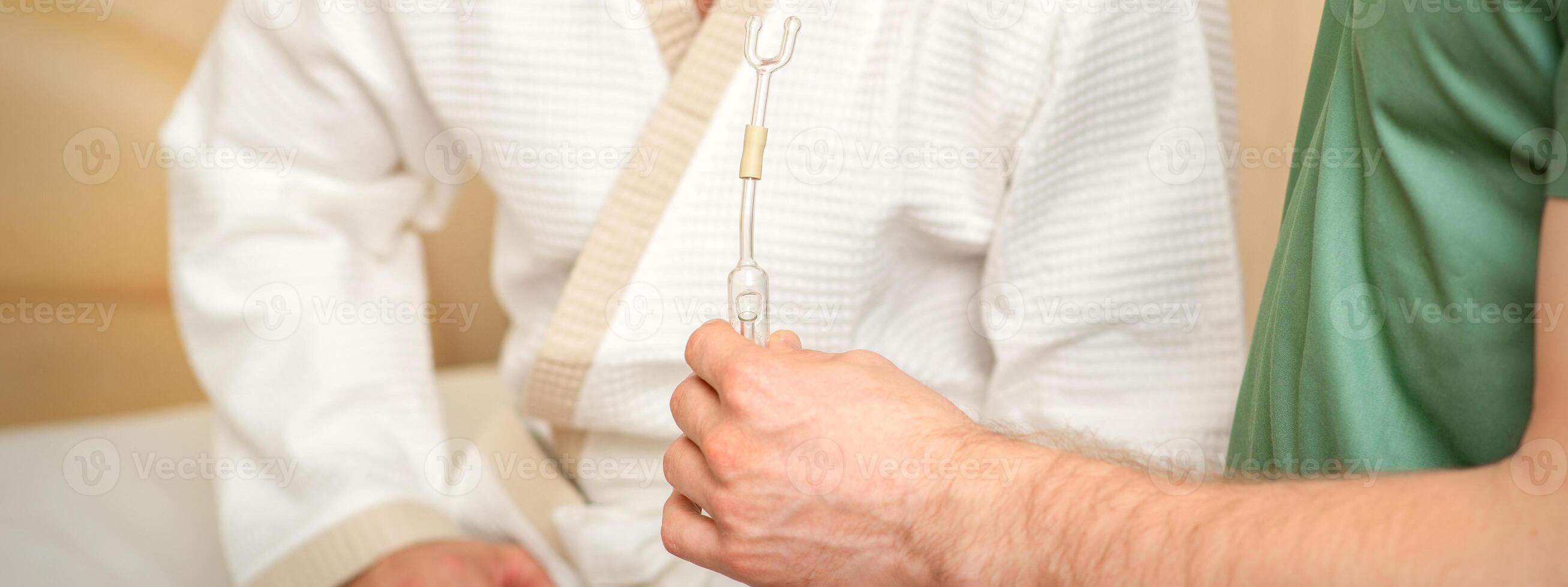 Doctor giving nasal inhalator with essential oil Maholda to a male patient in spa. photo