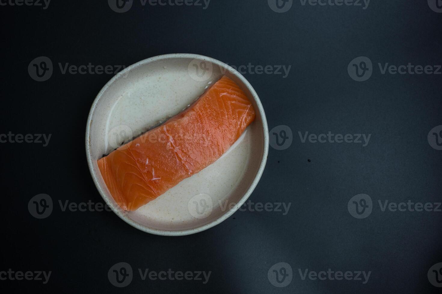 Portioned raw salmon fillets photo
