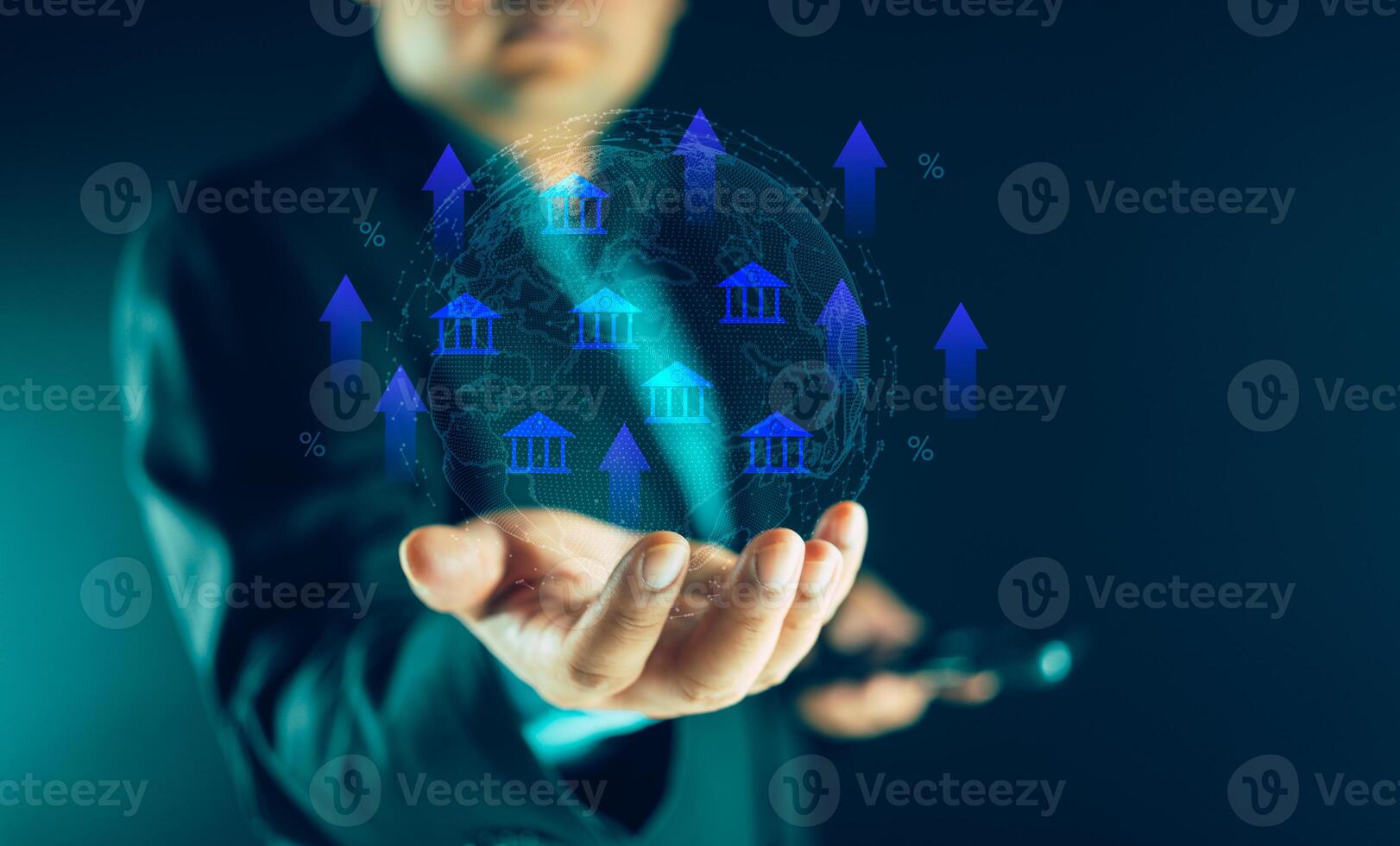 Businessman holding virtual world map and glowing percentage sign with up arrow symbol and bank icons photo