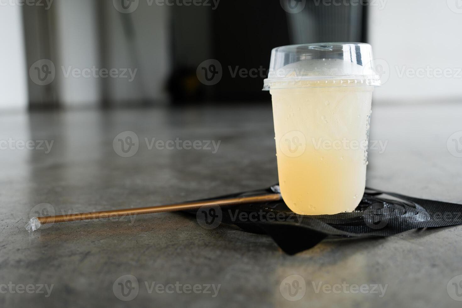 A glass of cold lemon juice mixed with honey photo