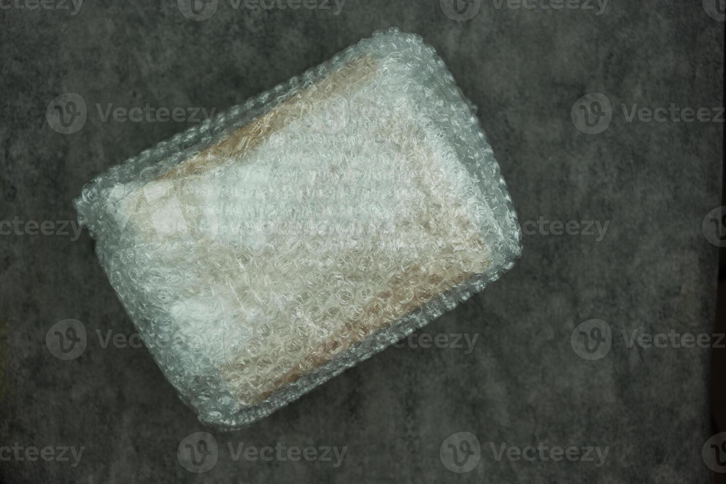 Paper box wrapped in plastic bubble wrap photo