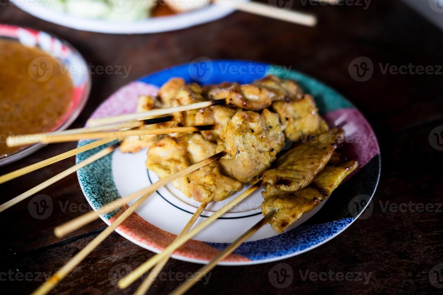 Pork satay served with dipping peanut sauce. photo
