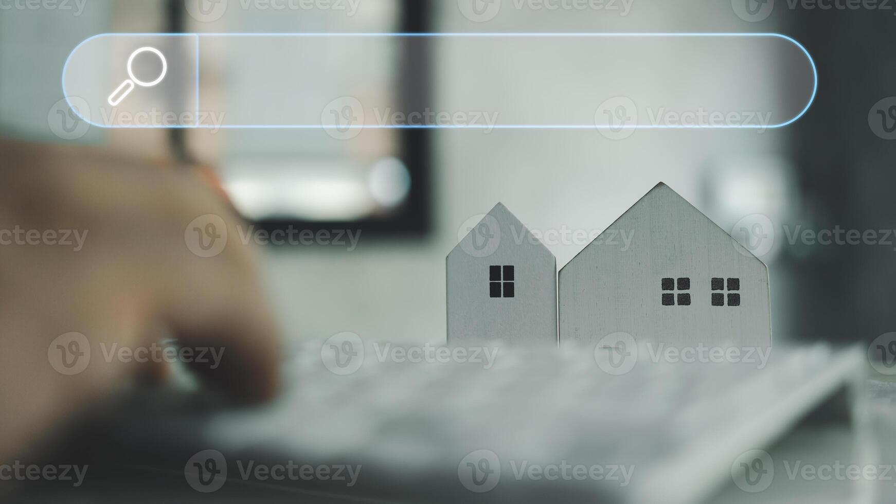 Man using keyboard with blank search bar and model home, search for find information data about home. photo