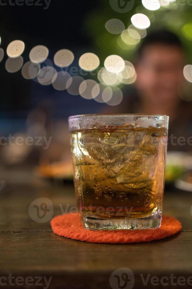 Glass of scotch whiskey mix with ice photo