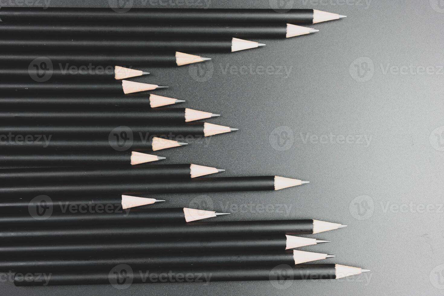 Black pencils on the matte black background. photo