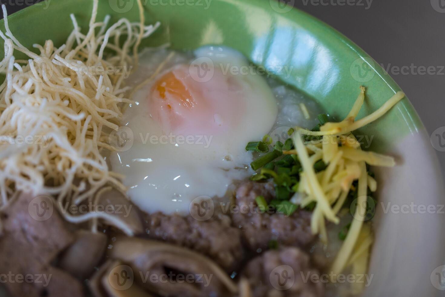 Congee with minced pork, liver, pork entrails and soft boiled in a bowl photo