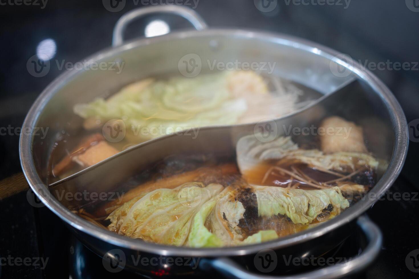 Japan food hotpot two styles of shabu soup. 2 in 1 soup in shabu pot . photo