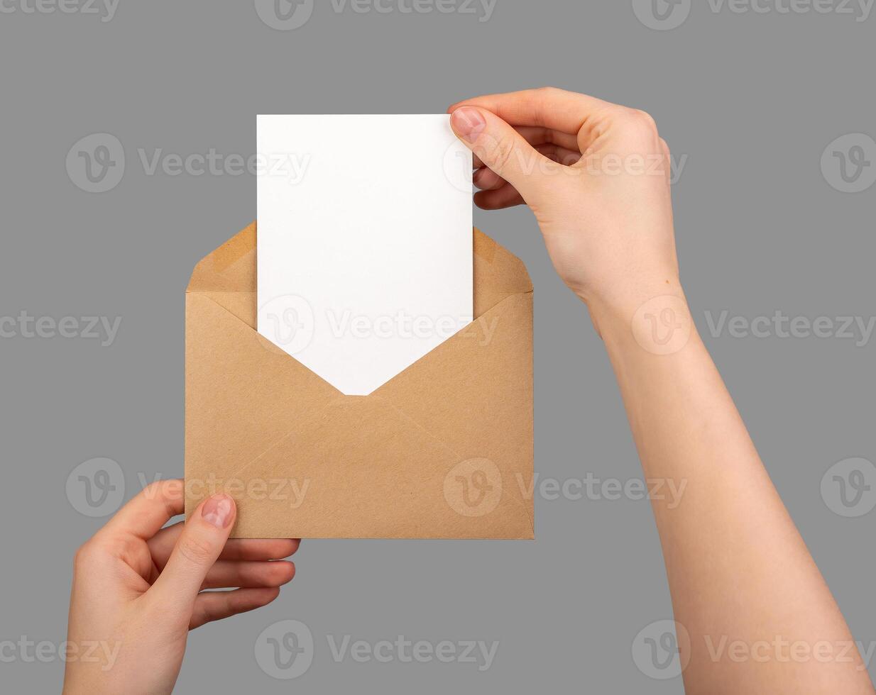 Postcard mockup, vertical blank card taking from paper envelope isolated on white photo