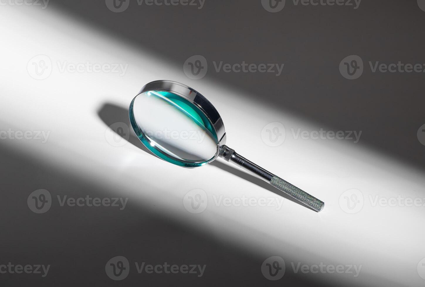 Glass lens magnifies, silver handle. Search concept, science object. Exploration, research, photo