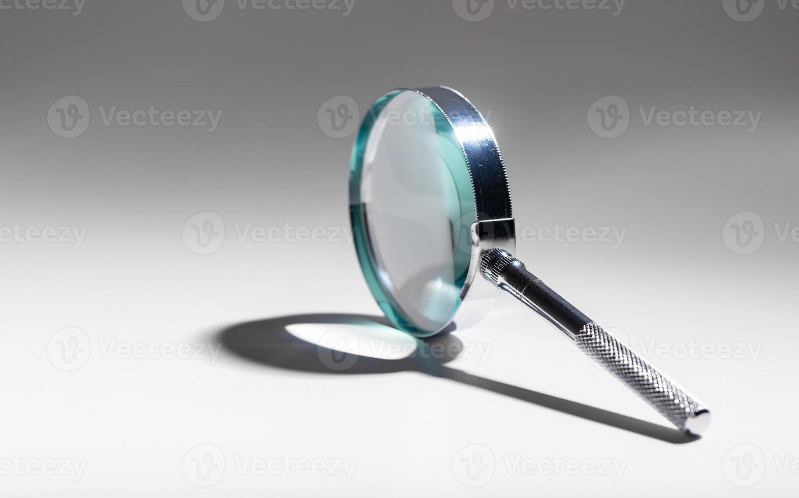 Magnify mystery with silver lens. Study, inspect, search. Abstract concept of scientific photo