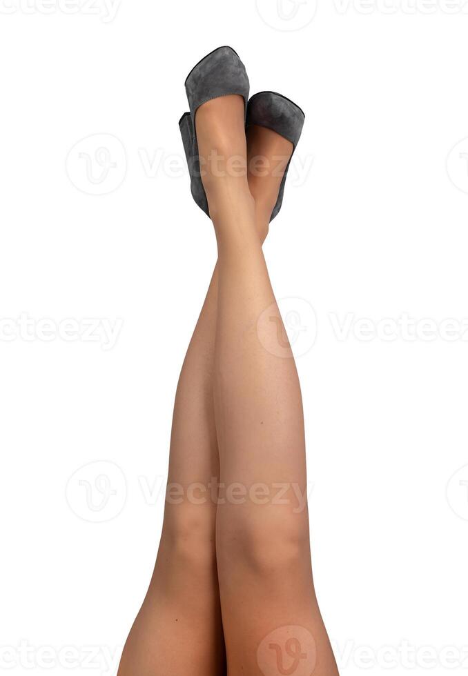 Female legs raised up, crossed pose, position, wearing gray heeled shoes isolated on white photo