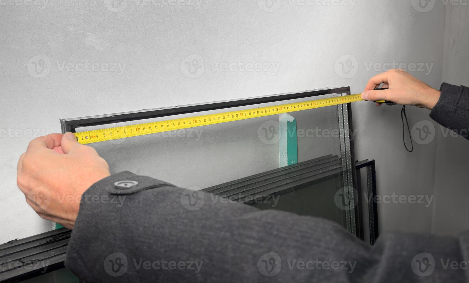 Hands with tape, measuring tool for construction industry photo