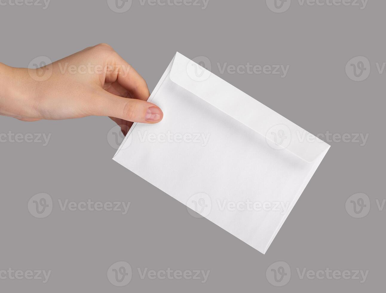 Hand holding white envelope, mail, paper letter isolated photo