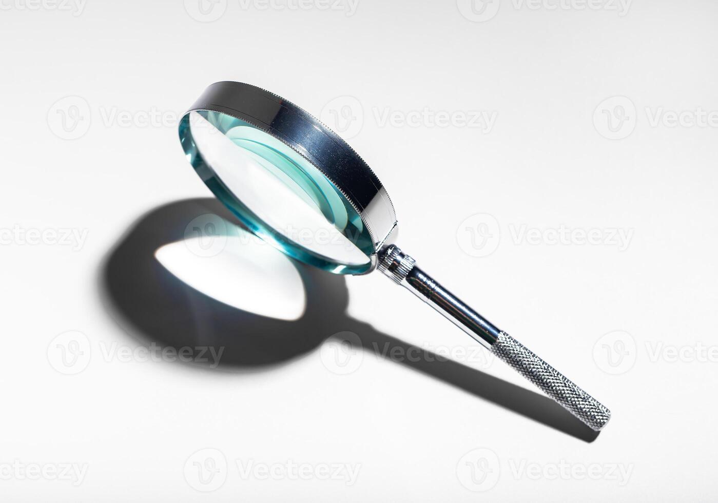 Silver metal magnifying glass. Optical concept for study, investigation, and exploration. Abstract photo