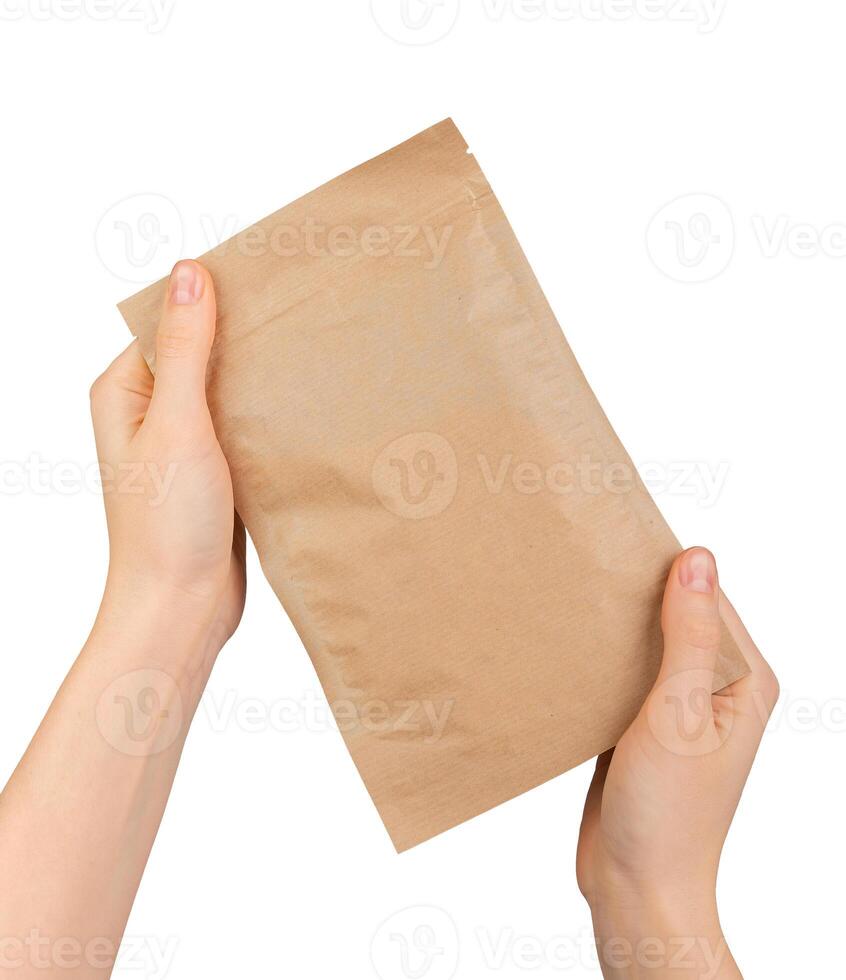 Hand holding ziplock paper bag. Zip-lock pouch, kraft eco package photo