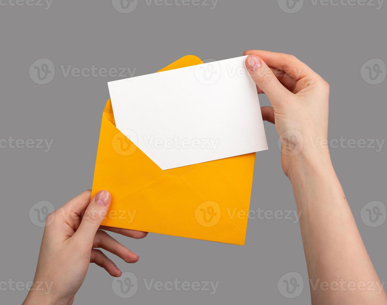 Holding an open envelope with a white card inside, blank horizontal postcard mockup photo