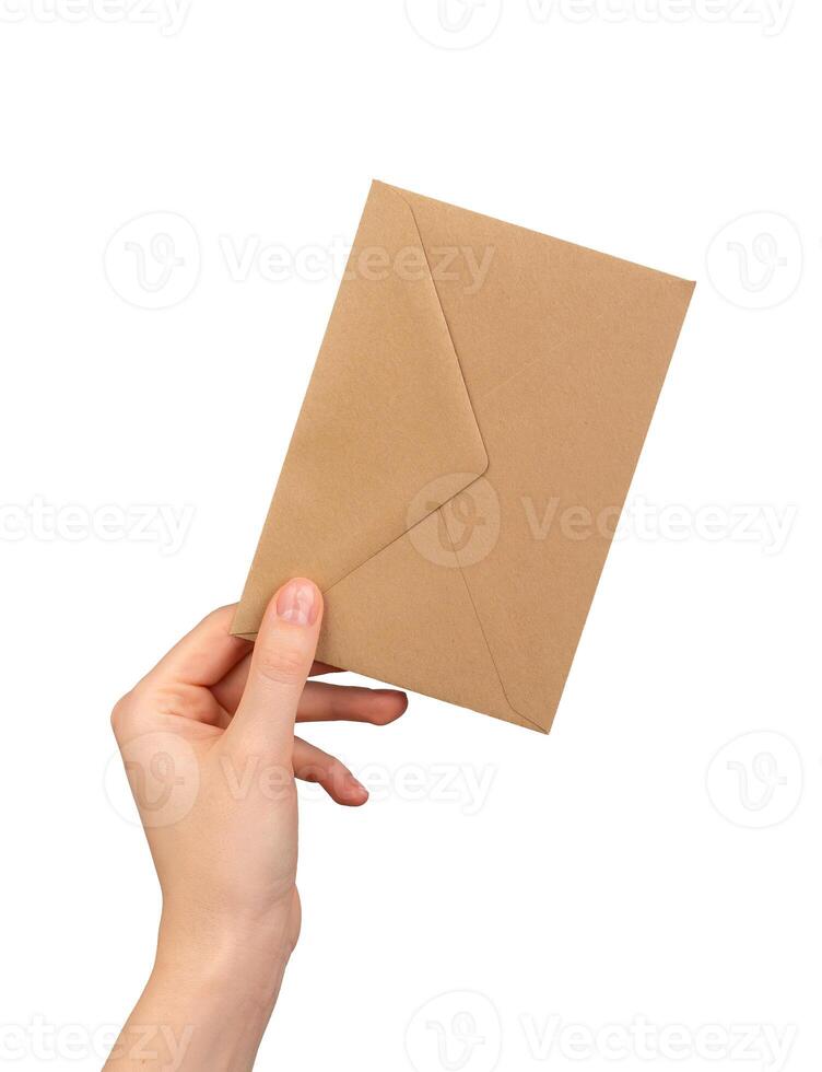 Brown kraft paper envelope in hand isolated on white background photo