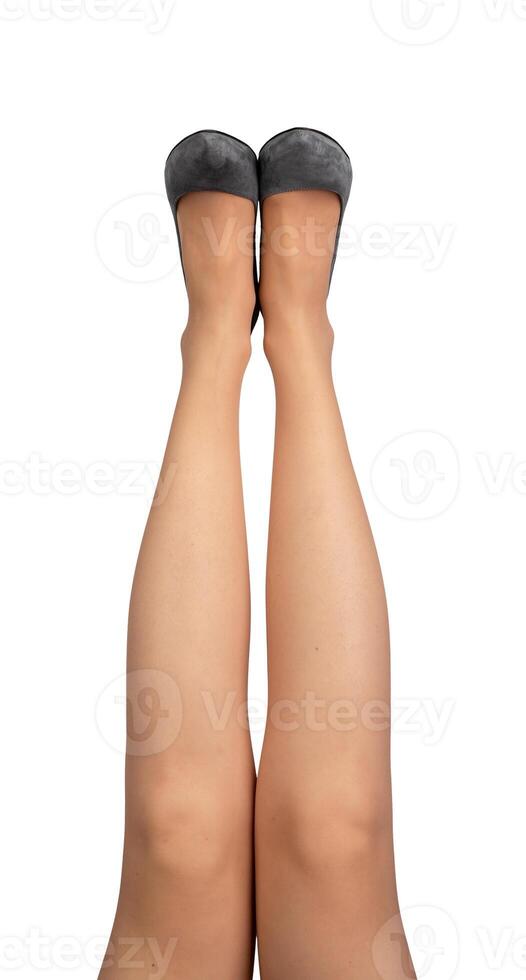 Women legs raised up, wearing gray heeled shoes isolated on white photo